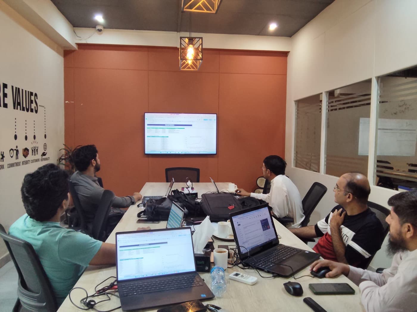 SellerCrush team leading a live Amazon training session in front of the core-values wall